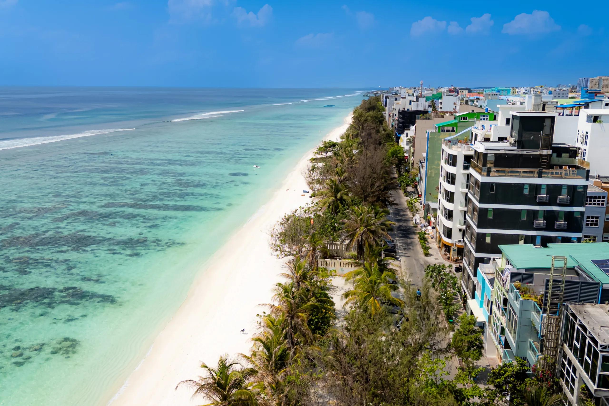 Hulhumalé beach with reef flats in the foreground and guesthouses along the shore