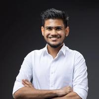 Ibrahim Faarih, founder and editor of Malé Travel Guide, smiling with arms crossed in a white shirt