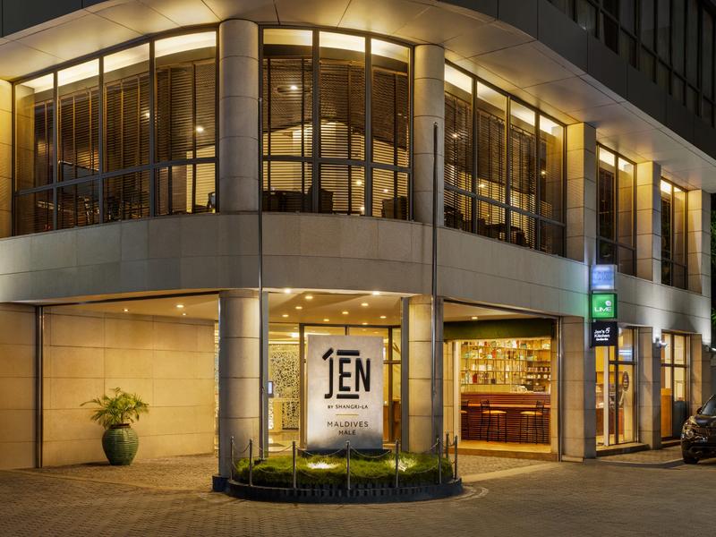 Illuminated street entrance of JEN Maldives Malé by Shangri-La at night