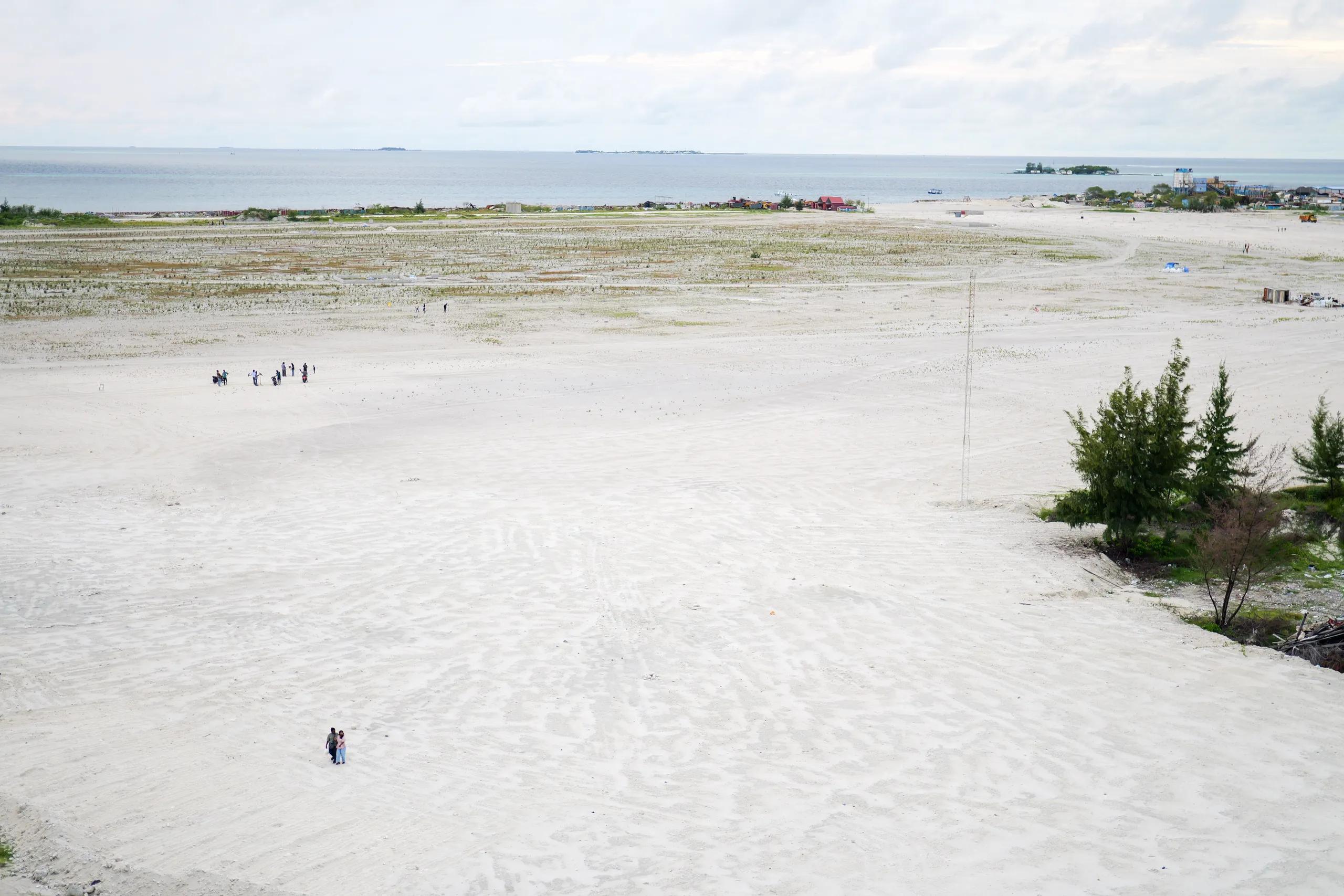 The newly reclaimed sand flats of Hulhumalé Phase 3, still mostly bare, with the lagoon and nearby islands beyond