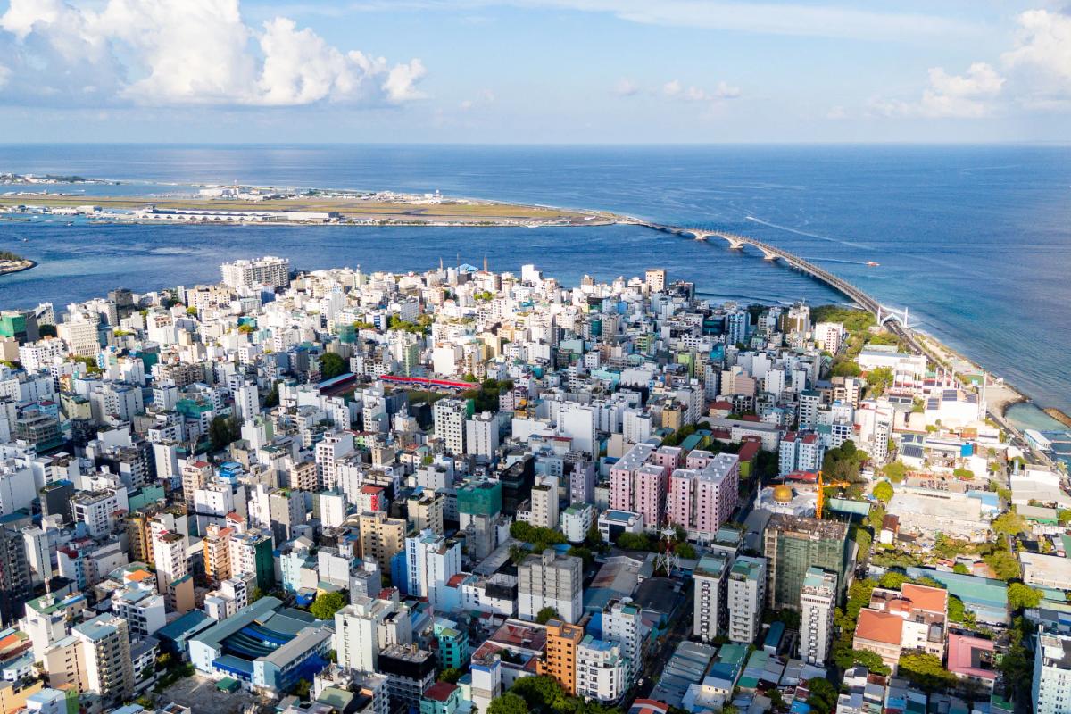 Drone view of Malé with the Sinamalé Bridge and Hulhulé on the horizon
