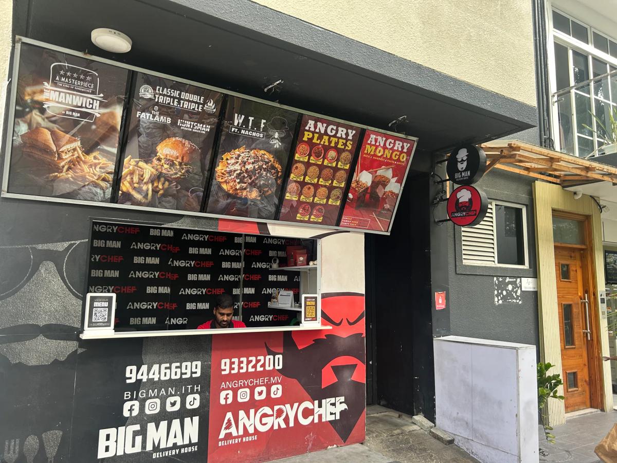 Angry Chef's red and black takeaway front shared with Big Man, menu boards mounted above the service window