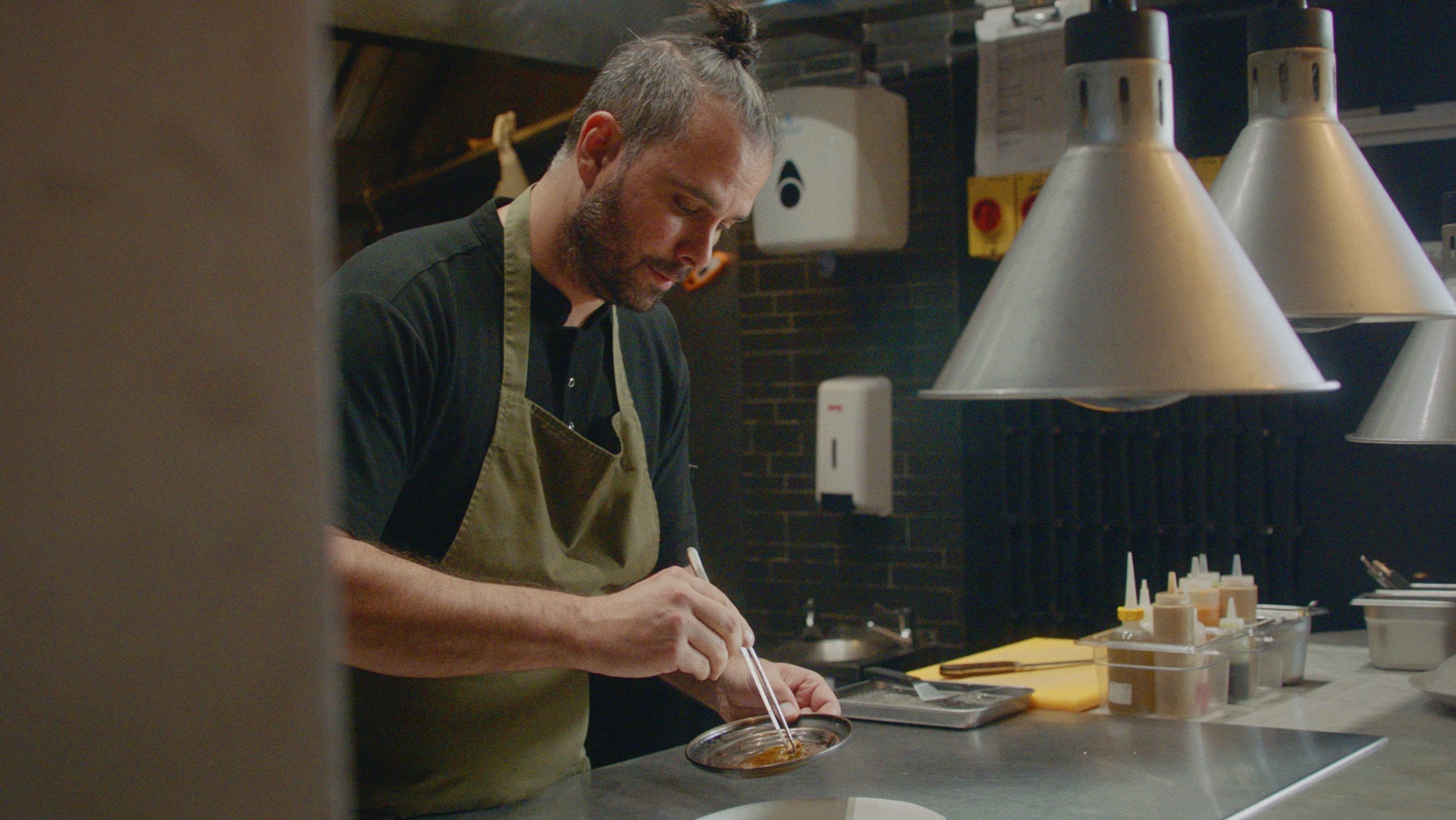 Antonio plating a dish in the kitchen