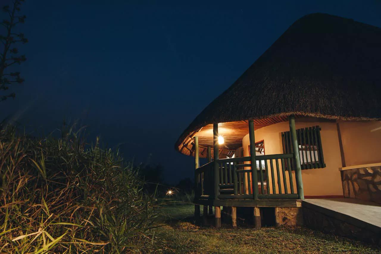 A guest cottage veranda lit at dusk