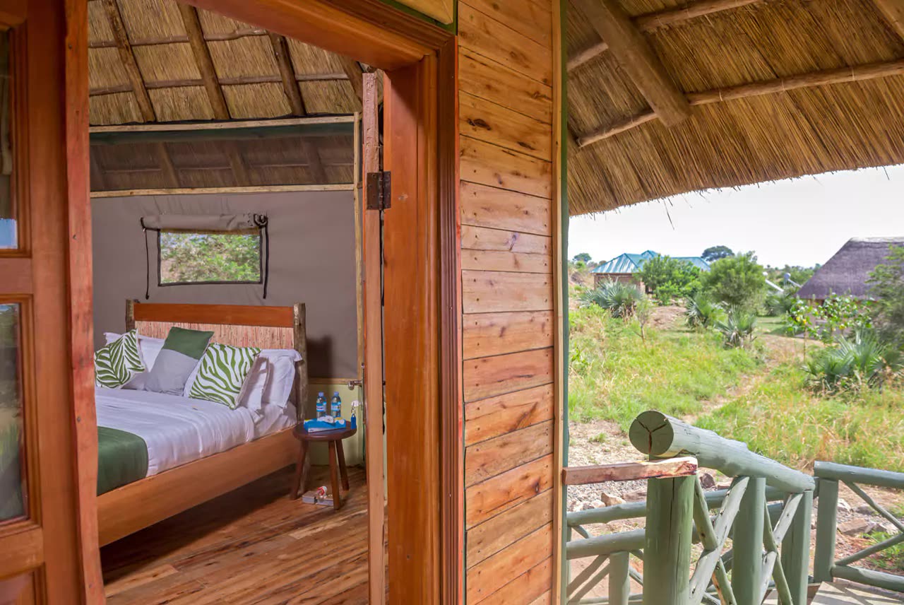 Elevated tent interior opening onto the bush