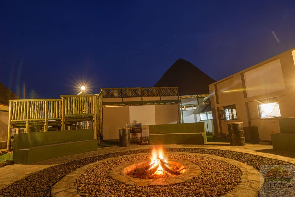 The campfire burning after dark