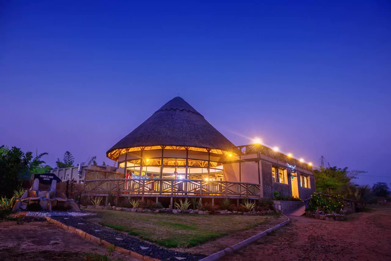 The round main lodge lit up at dusk