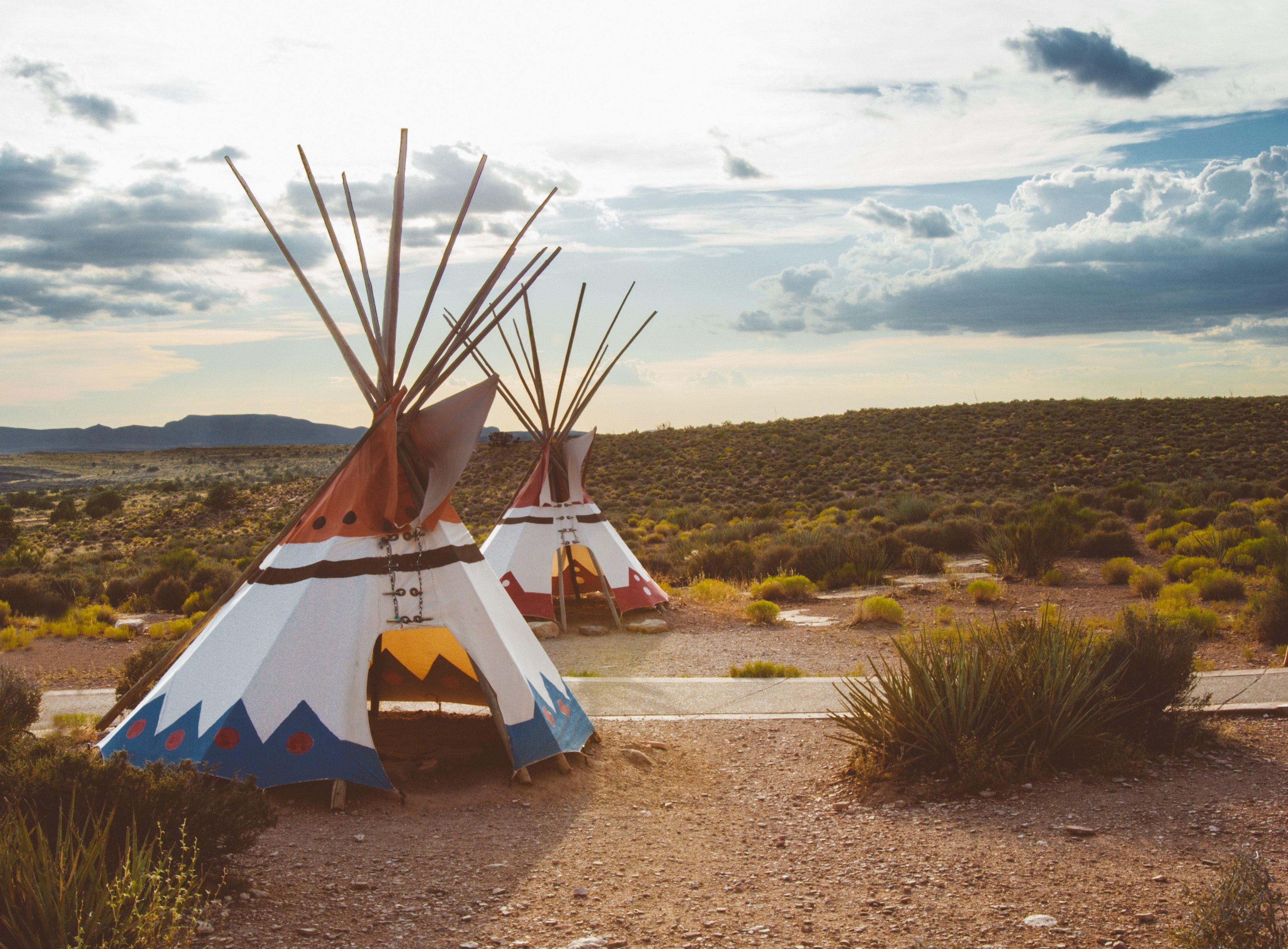 Desert landscape with tipis adjacent to a hiking trail.