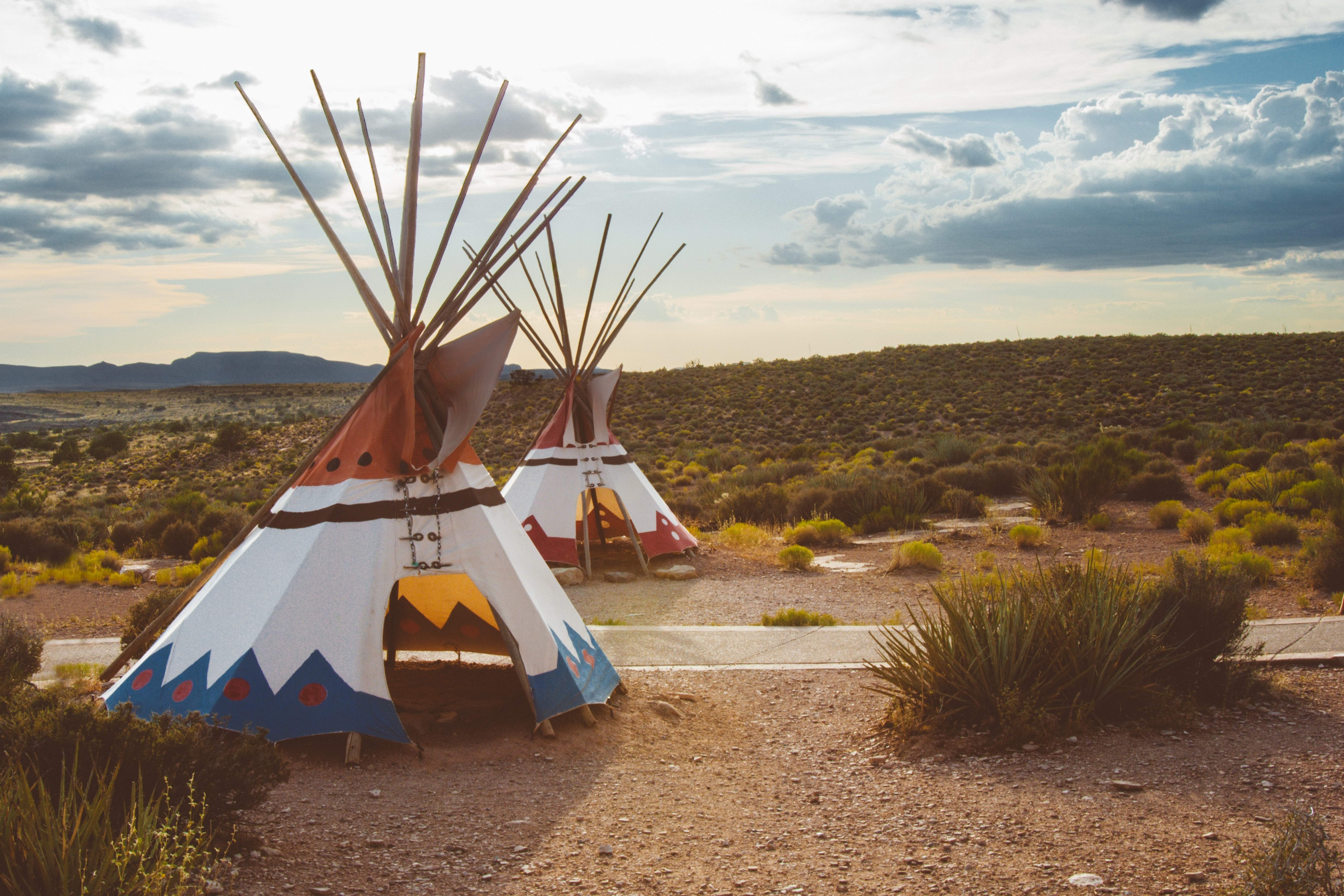 Desert landscape with tipis adjacent to a hiking trail.
