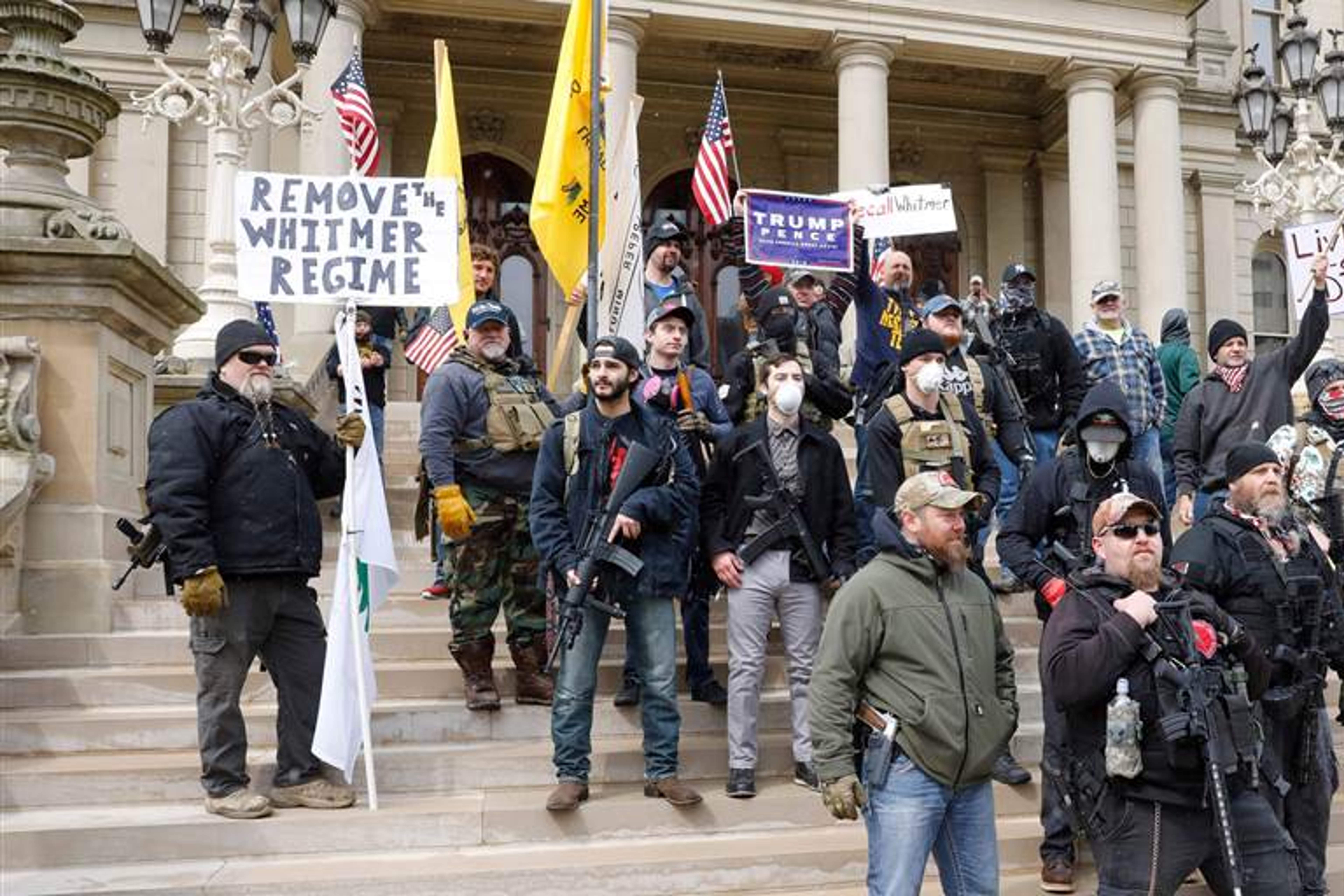 A crowd of pathetic men with weapons gathers on the Michigan capitol stairs