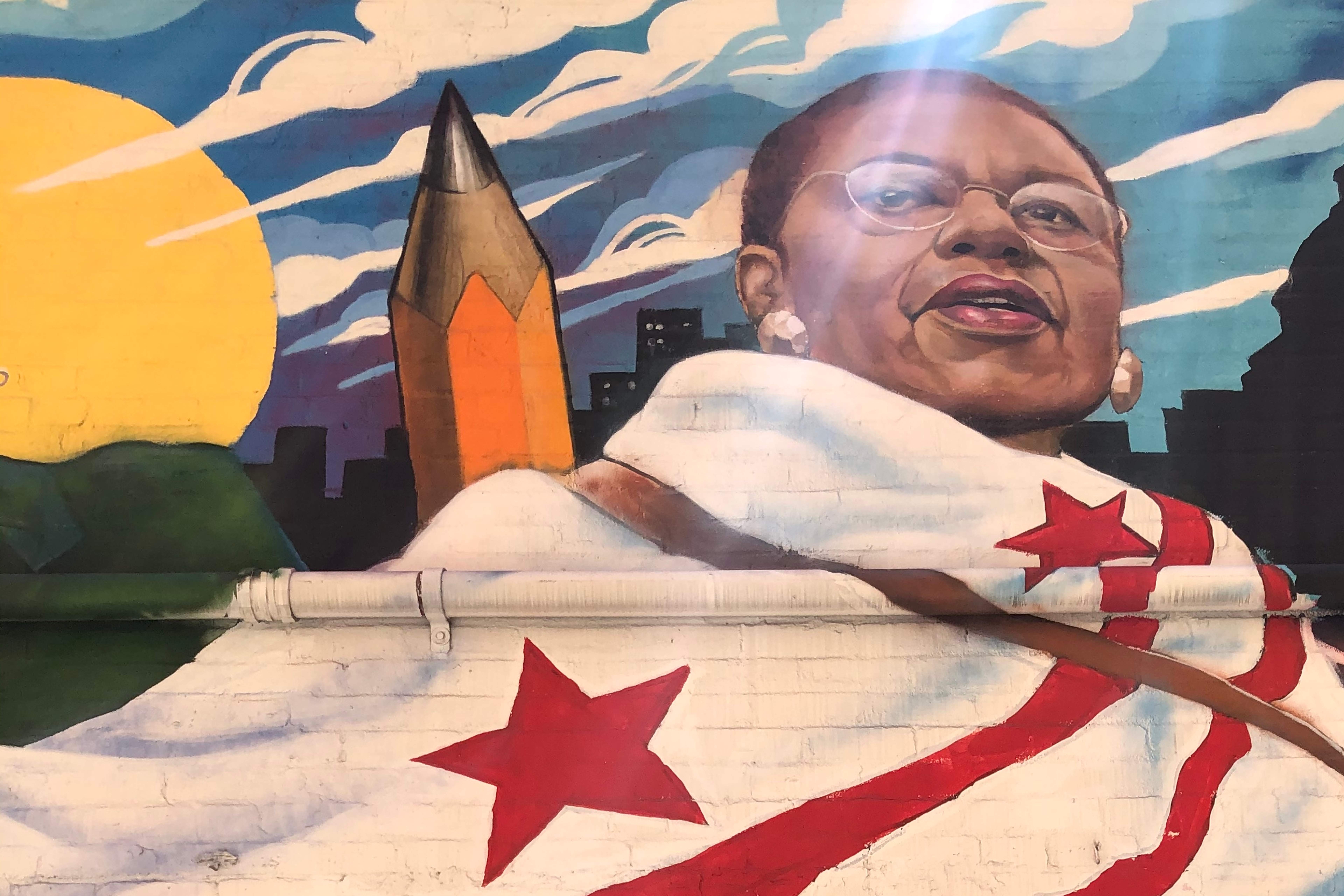 Inspiring mural of Eleanor Holmes Norton with a DC flag wrapped around her