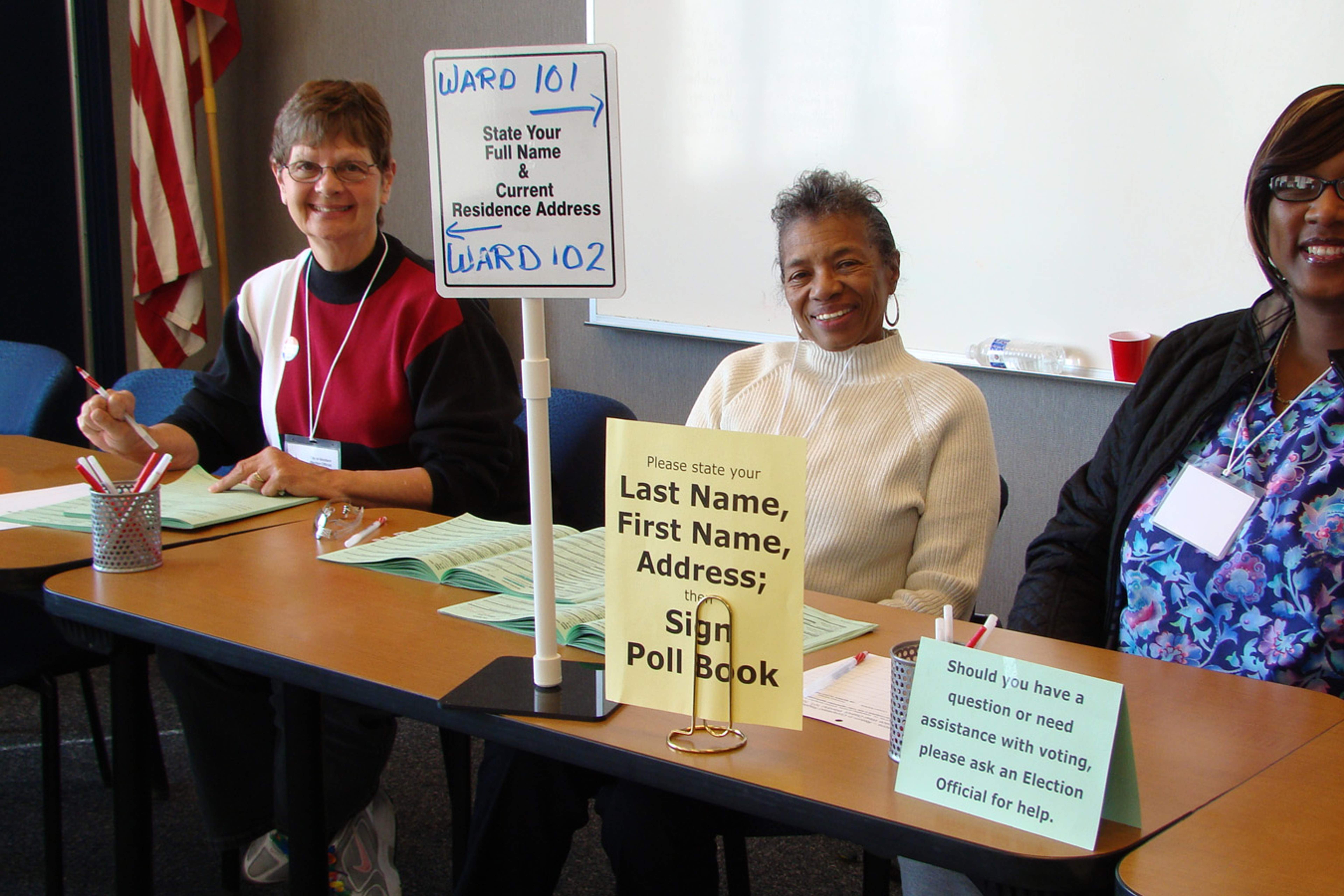 Three poll workers seated at a polling place in Madison, Wisconsin