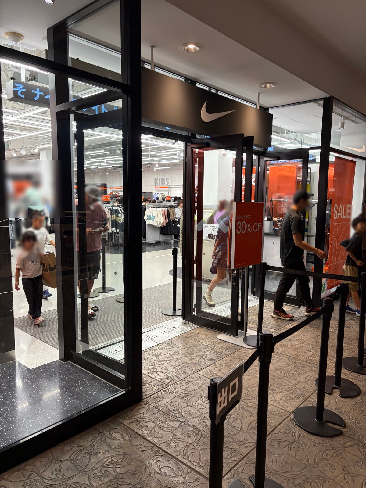 NIKEの入口。ガラス越しに店内が見え、奥に KIDS の表示がある