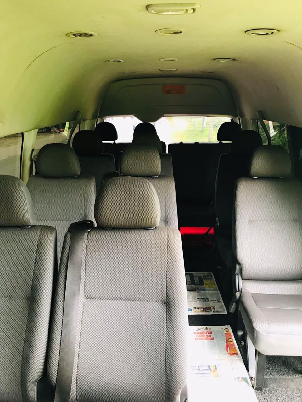 Inside Adhi's comfortable air-conditioned Toyota van, with cushioned seating and plenty of room for larger groups and families