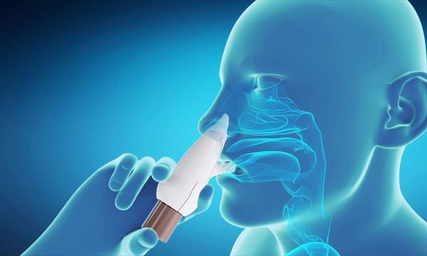 A person using the Xhance nasal spray device