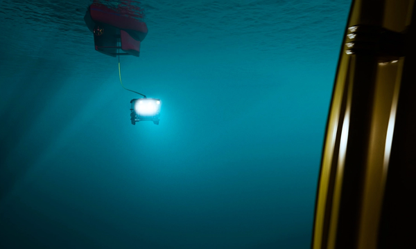 A remotely operated subsea vehicle attached by umbilical to a subsea vessel. 