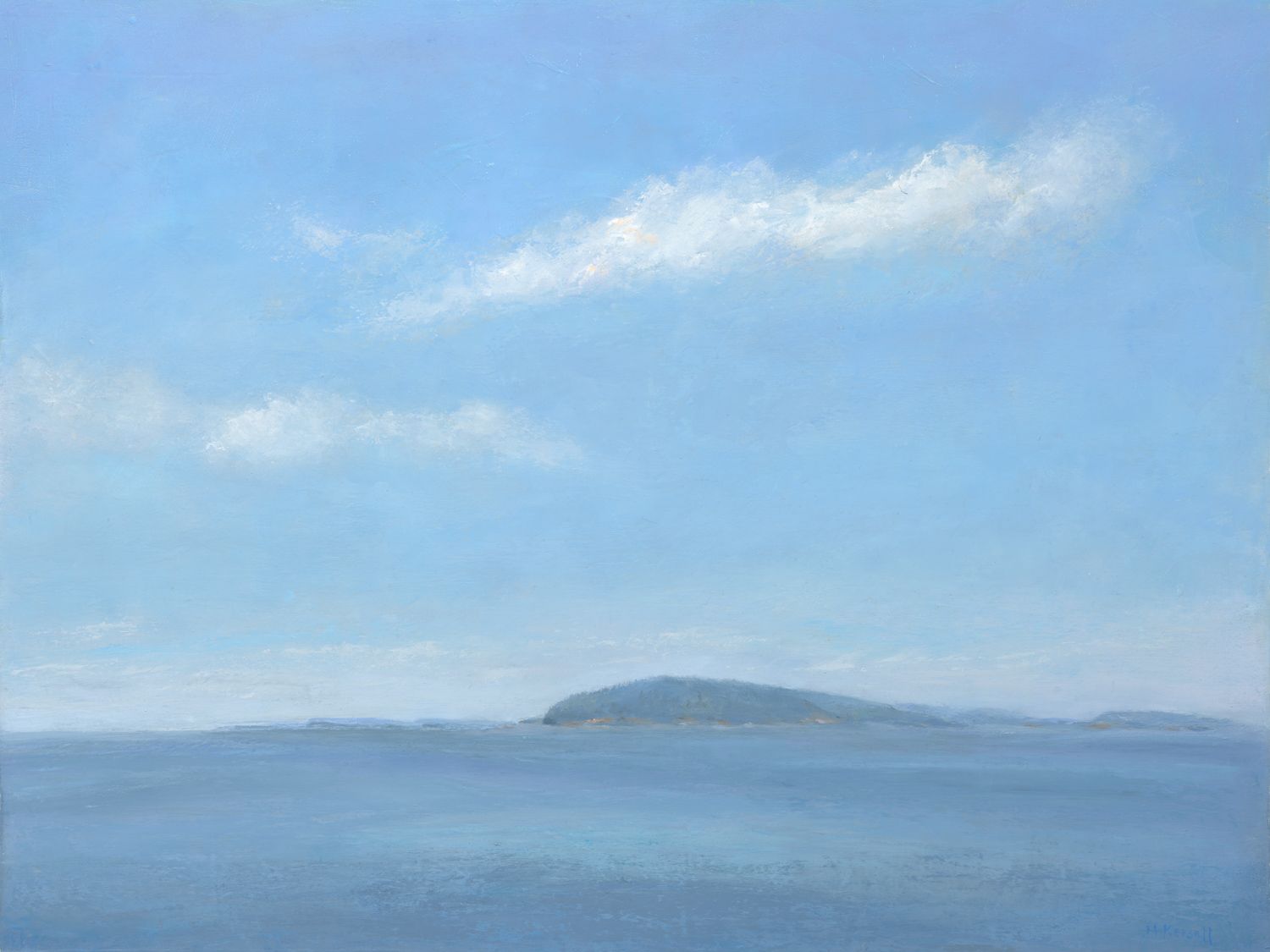 Distant Island with passing clouds on a hot summer day.