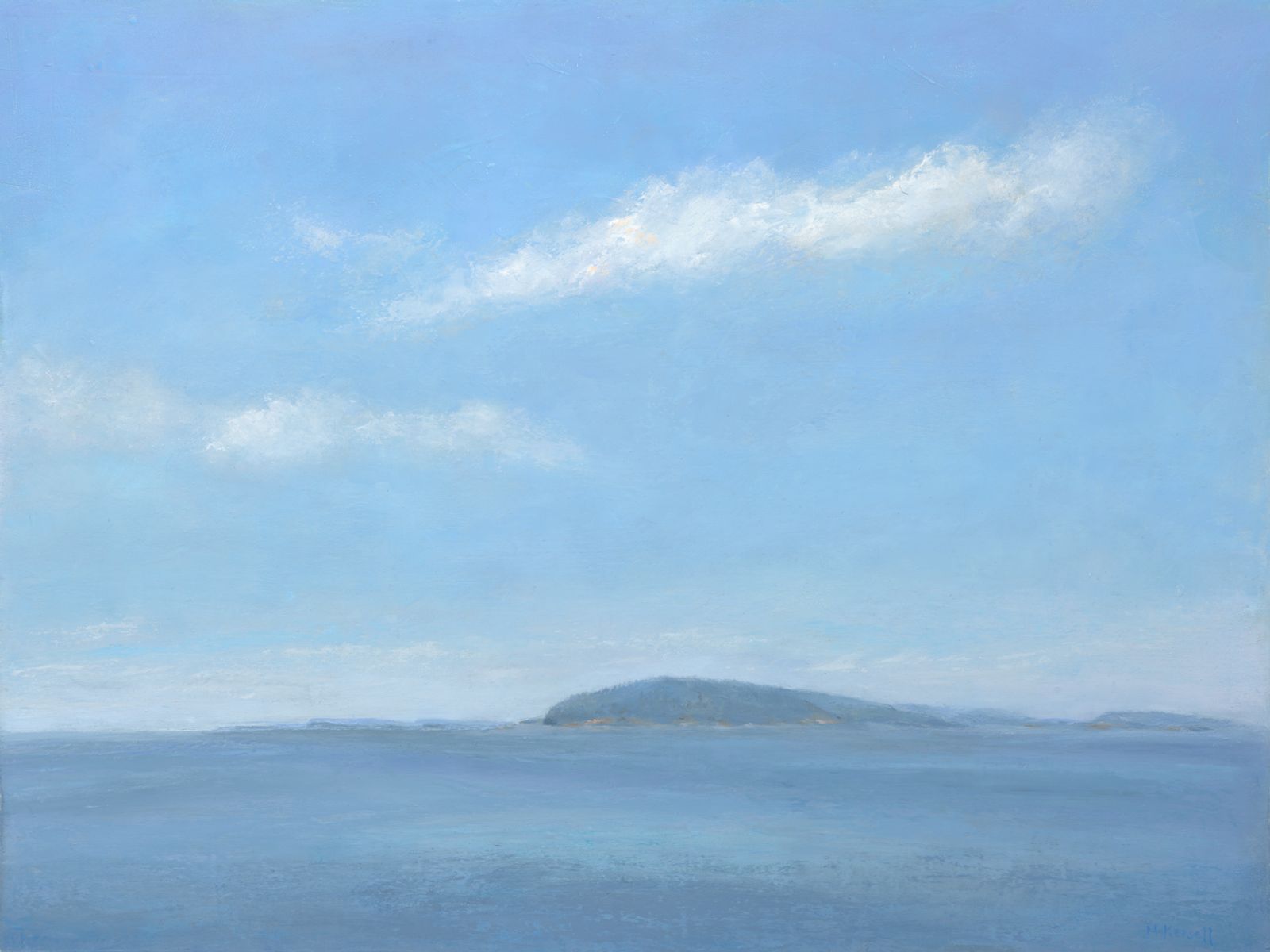 Distant Island with passing clouds on a hot summer day.