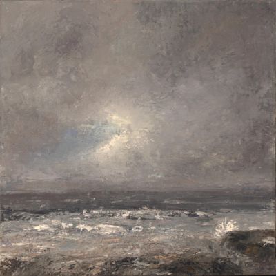 A stormy day with waves crashing on the shore. The sun breaks through.