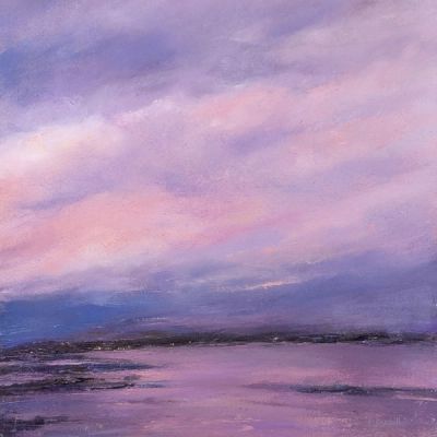 A pink sunset over a distant shore. The whole sky is coloured.