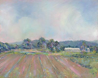 This is a Plein Air oil painting of summer fields reaching toward distant  trees and hills. A low barn is in the mid-ground. Soft billowing clouds are above. The color is imagined.