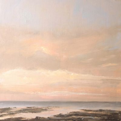 A rosy sunset over a rocky outcrop.