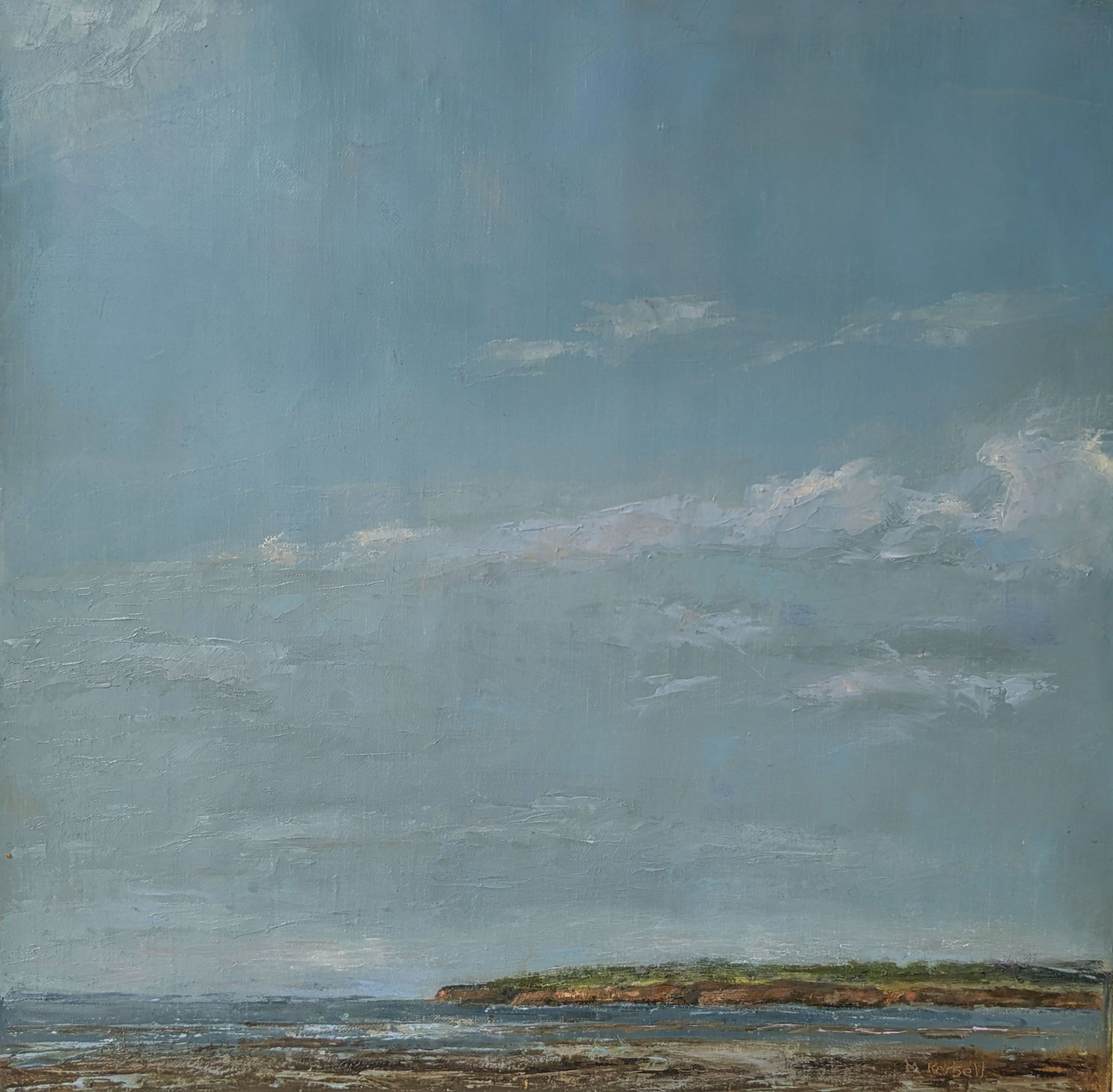 A distant headland, clouds floating above.