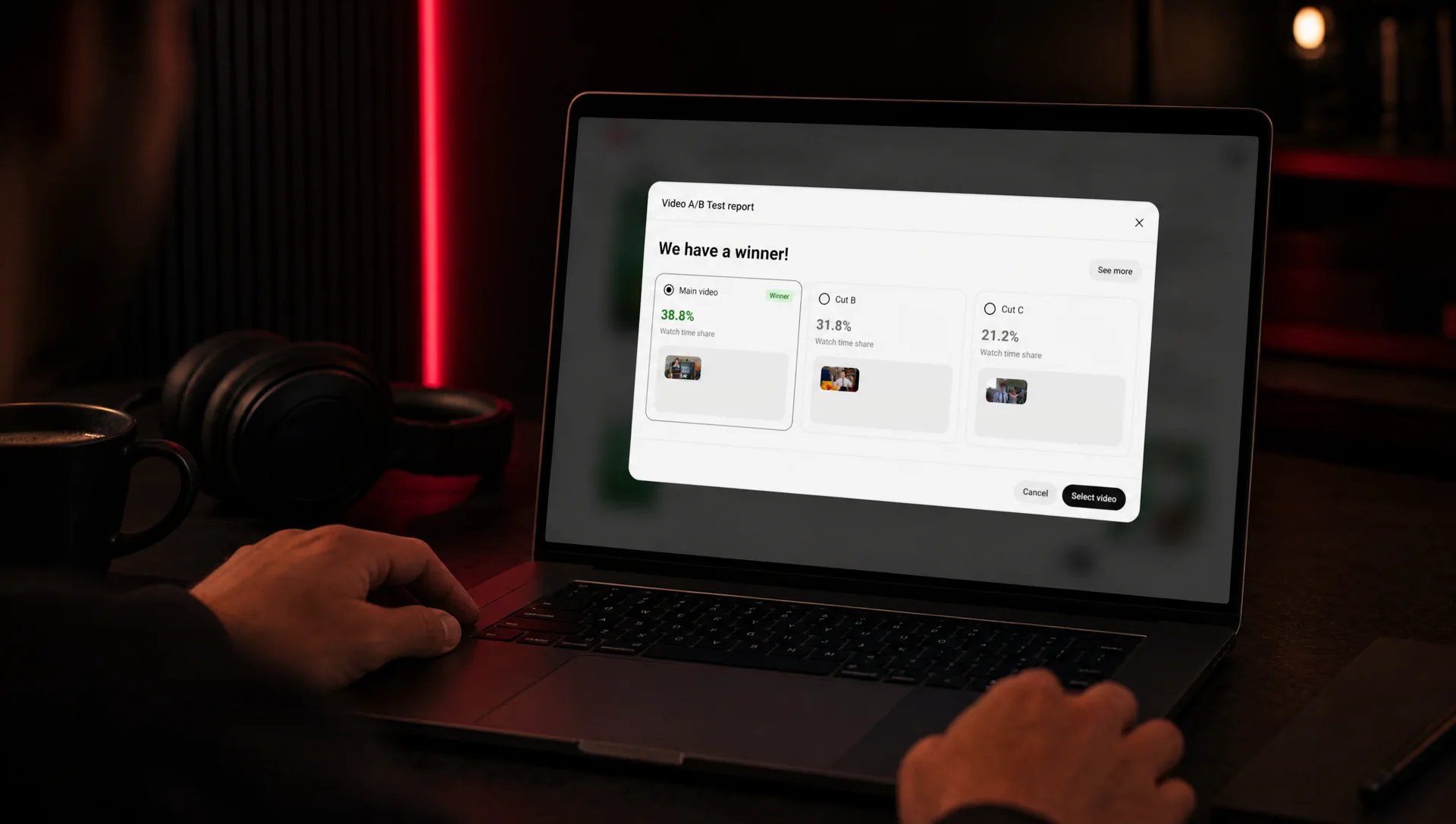 MacBook in a dark editing room lit in red, the screen showing YouTube Studio’s video A/B test report “We have a winner!” with three cuts compared, the editor’s hands on the keyboard