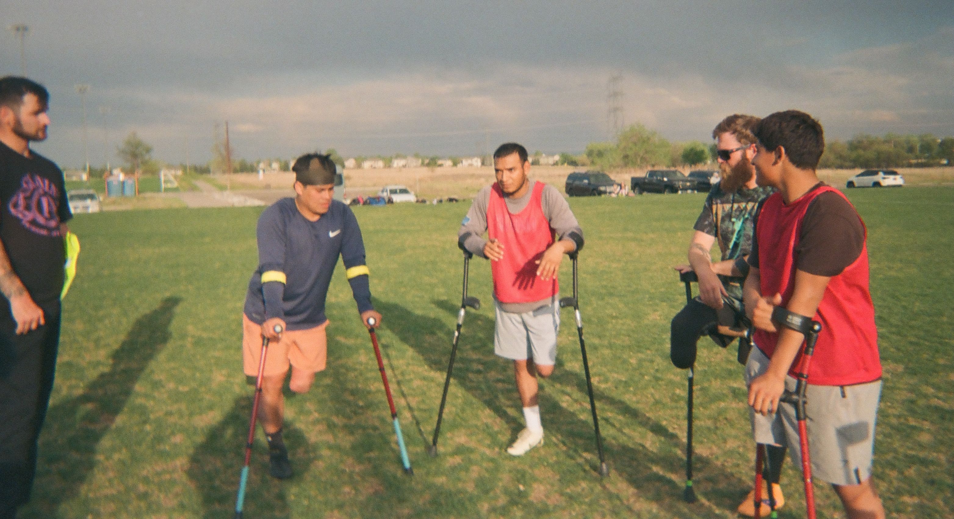 Amputee soccer players talking together during training.