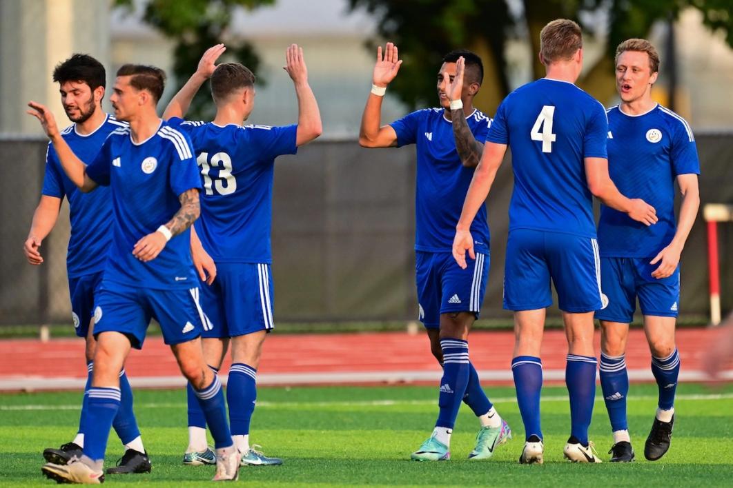 photo of teammates wearing Pancyprian blue uniforms high fiving
