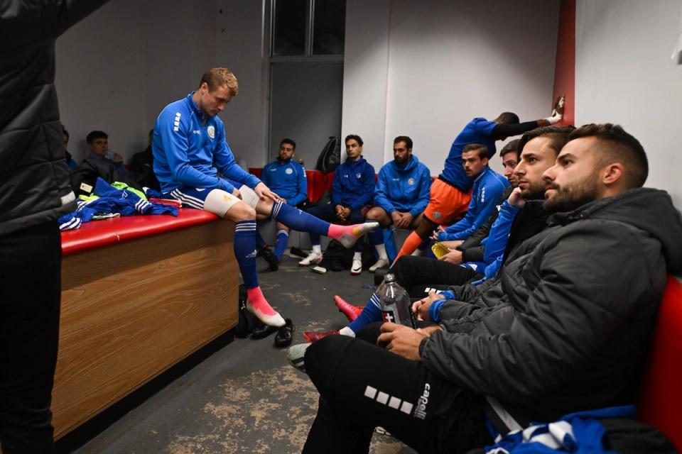 photo of team gathered together in locker room