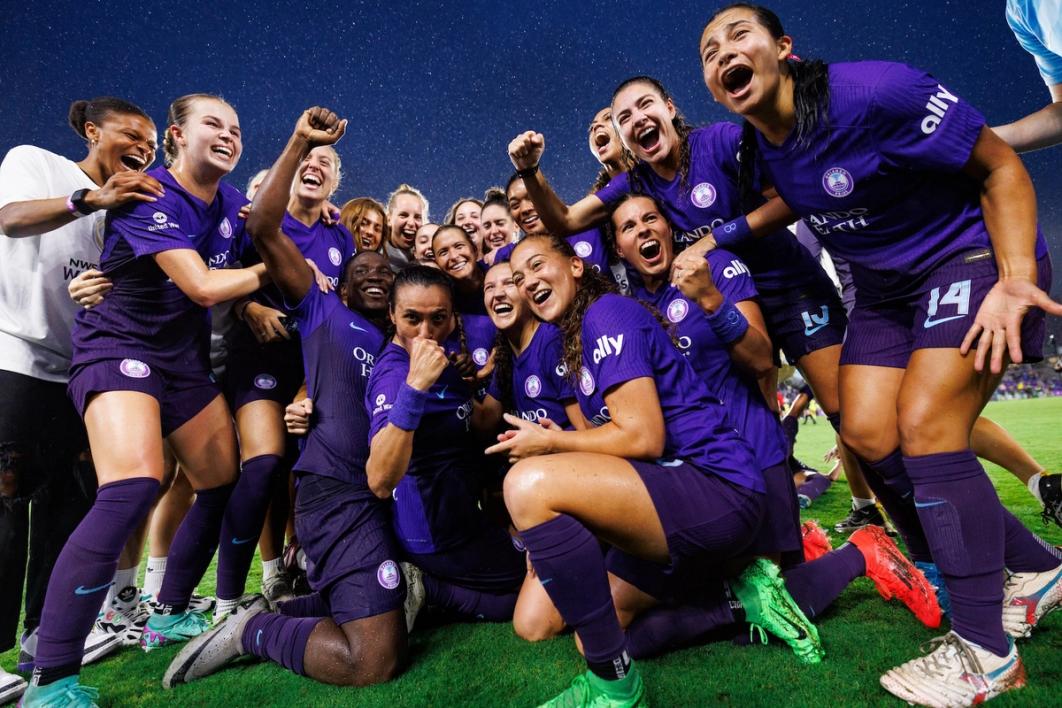 The Orlando Pride celebrate winning the NWSL Shield on the field