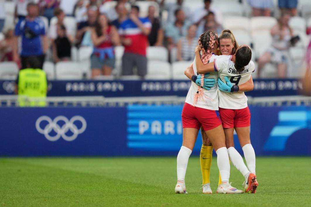 Alyssa Naeher, Trinity Rodman and Mallory Swanson hug following the USA's win over Germany in the Olympic semifinal.