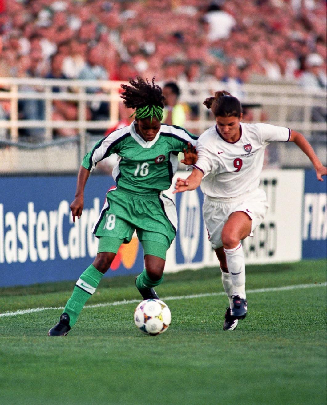 A USA and Nigerian player fight for the ball during the 1999 Womens World Cup match at Soldier Field