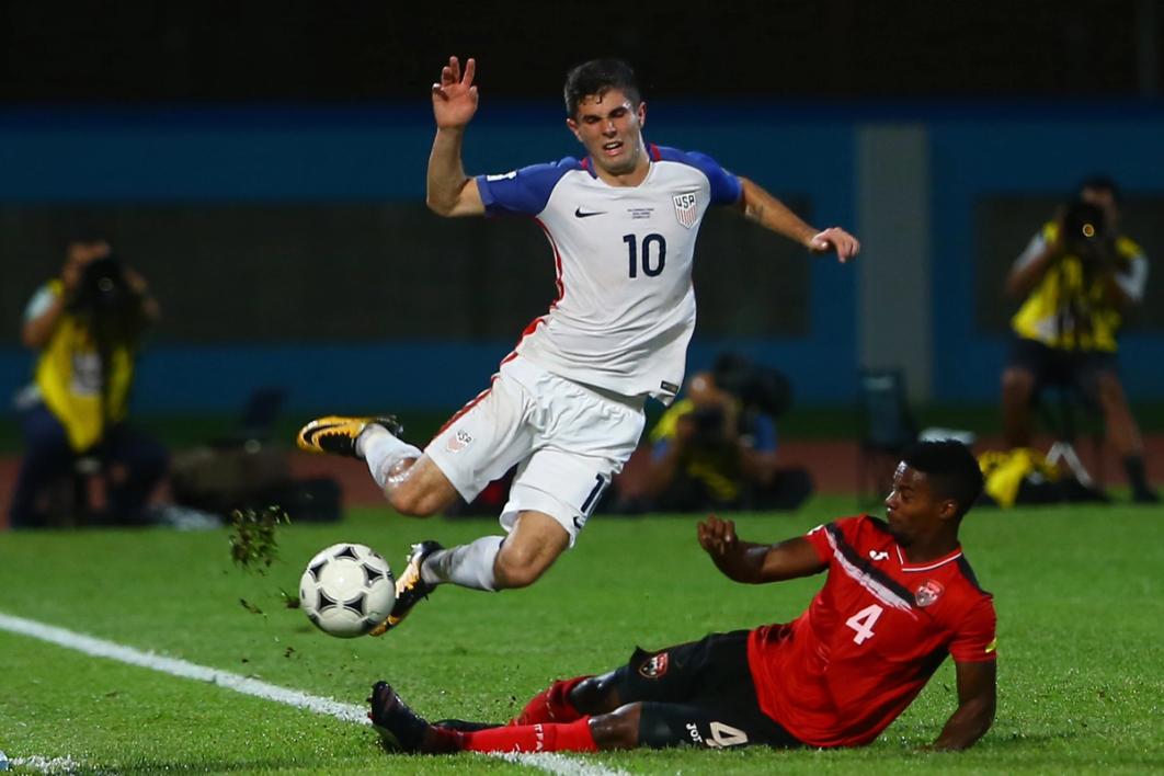 Christian Pulisic is tackled by Trinidad and Tobago's Kevon Villaroel during the FIFA World Cup Qualifier match between Trinidad and Tobago at the Ato Boldon Stadium on October 10, 2017 in Couva, Trinidad and Tobago (Photo by Ashley Allen/Getty Images)
