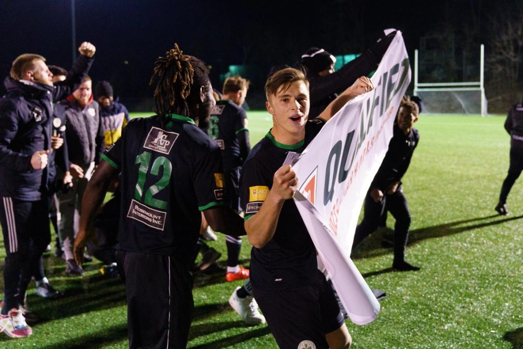 A player holds a qualified banner from the 2024 US Open Cup