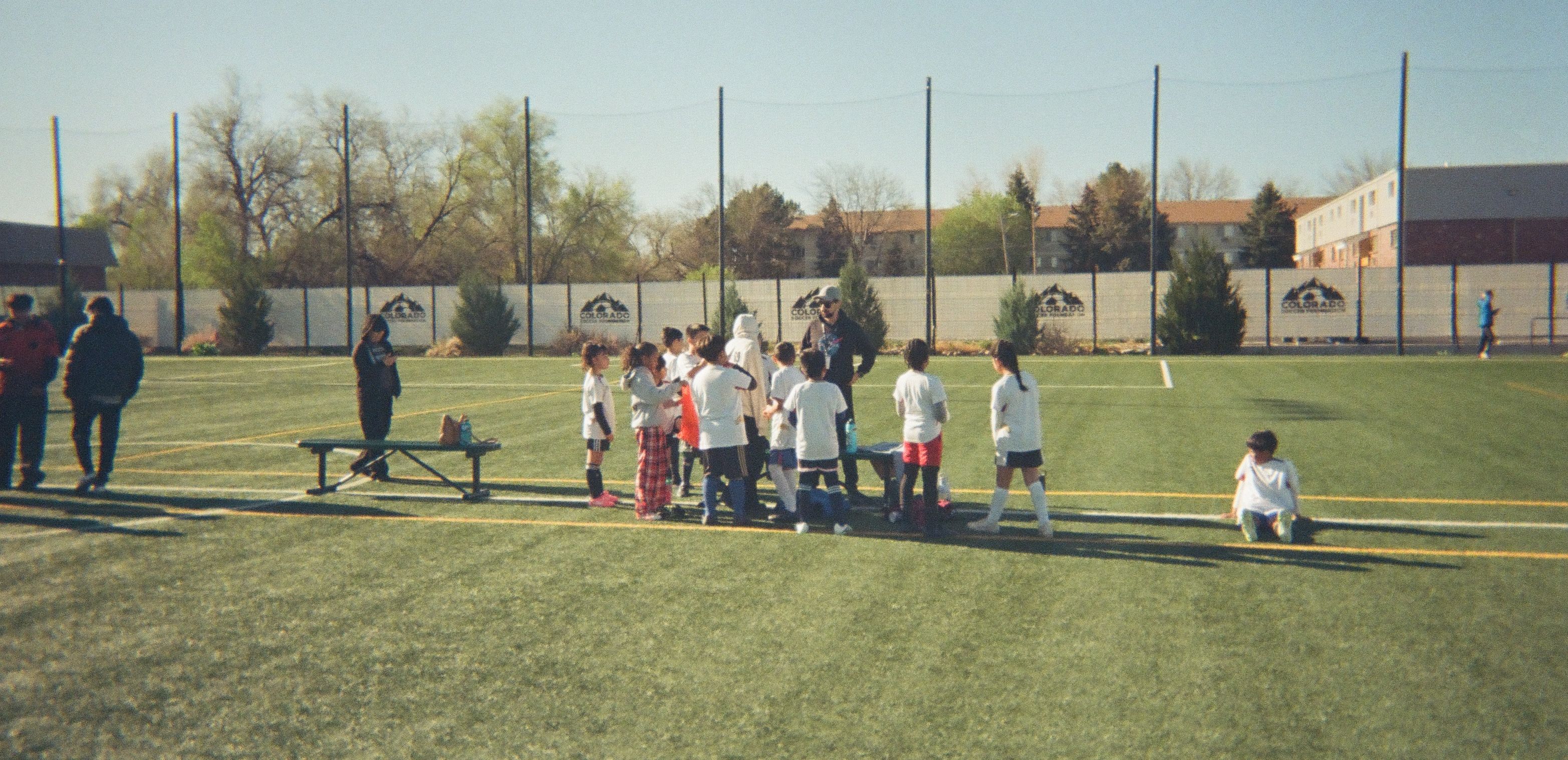 A group of amputee soccer players pose for a photo after soccer practice.