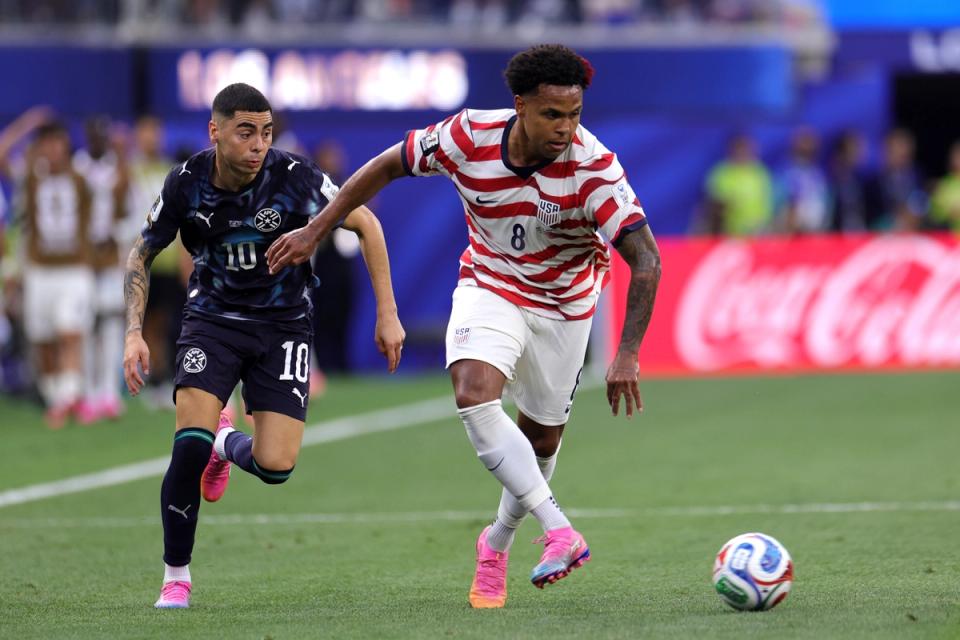Weston McKennie of the United States passes the ball under pressure from Miguel Almiron #10 of Paraguay (Photo by John Dorton/USSF/Getty Images)