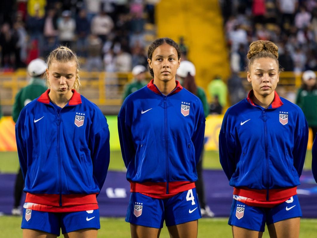 Jordyn Bugg in blue warmup gear stands at midfield before a match flanked by two teammates​​​​‌﻿‍﻿​‍​‍‌‍﻿﻿‌﻿​‍‌‍‍‌‌‍‌﻿‌‍‍‌‌‍﻿‍​‍​‍​﻿‍‍​‍​‍‌﻿​﻿‌‍​‌‌‍﻿‍‌‍‍‌‌﻿‌​‌﻿‍‌​‍﻿‍‌‍‍‌‌‍﻿﻿​‍​‍​‍﻿​​‍​‍‌‍‍​‌﻿​‍‌‍‌‌‌‍‌‍​‍​‍​﻿‍‍​‍​‍‌‍‍​‌﻿‌​‌﻿‌​‌﻿​​‌﻿​﻿​﻿‍‍​‍﻿﻿​‍﻿﻿‌﻿‌‌‌﻿​﻿‌﻿​﻿‌‍‌‍​‍﻿‍‌﻿​﻿‌‍​‌‌‍﻿‍‌‍‍‌‌﻿‌​‌﻿‍‌​‍﻿‍‌﻿​﻿‌﻿‌​‌﻿‌‌‌‍‌​‌‍‍‌‌‍﻿﻿​‍﻿﻿‌‍‍‌‌‍﻿‍‌﻿‌​‌‍‌‌‌‍﻿‍‌﻿‌​​‍﻿﻿‌‍‌‌‌‍‌​‌‍‍‌‌﻿‌​​‍﻿﻿‌‍﻿‌‌‍﻿﻿‌‍‌​‌‍‌‌​﻿﻿‌‌﻿​​‌﻿​‍‌‍‌‌‌﻿​﻿‌‍‌‌‌‍﻿‍‌﻿‌​‌‍​‌‌﻿‌​‌‍‍‌‌‍﻿﻿‌‍﻿‍​﻿‍﻿‌‍‍‌‌‍‌​​﻿﻿‌‌‍‌‌​﻿​‌​﻿‍​​﻿‍‌​﻿‌​‌‍​‍​﻿​‍‌‍​‌​‍﻿‌‌‍‌‍​﻿‍​‌‍‌‌​﻿‍​​‍﻿‌​﻿‌​​﻿‌‌‌‍‌‍​﻿‍‌​‍﻿‌‌‍​‌‌‍‌‍​﻿​​‌‍​‌​‍﻿‌​﻿​‍​﻿‌﻿​﻿‌​​﻿​﻿​﻿‍​​﻿​﻿‌‍‌‌​﻿‍​​﻿​‍‌‍​‌‌‍‌​​﻿‌﻿​﻿‍﻿‌﻿‌​‌﻿‍‌‌﻿​​‌‍‌‌​﻿﻿‌‌﻿​﻿‌﻿‌​‌‍﻿﻿‌﻿​‍‌﻿‍‌​﻿‍﻿‌﻿​​‌‍​‌‌﻿‌​‌‍‍​​﻿﻿‌‌‍​﻿‌‍﻿﻿‌‍﻿‍‌﻿‌​‌‍‌‌‌‍﻿‍‌﻿‌​​‍‌‌​﻿‌‌‌​​‍‌‌﻿﻿‌‍‍﻿‌‍‌‌‌﻿‍‌​‍‌‌​﻿​﻿‌​‌​​‍‌‌​﻿​﻿‌​‌​​‍‌‌​﻿​‍​﻿​‍​﻿‍​​﻿‌​​﻿‌​‌‍​‍​﻿‌‍​﻿​‍​﻿​‍​﻿​‌‌‍‌‌‌‍‌‍​﻿‌​‌‍‌​​‍‌‌​﻿​‍​﻿​‍​‍‌‌​﻿‌‌‌​‌​​‍﻿‍‌‍‍‌‌‍﻿‌‌‍​‌‌‍‌﻿‌‍‌‌​‍﻿‍‌‍​‌‌‍﻿​‌﻿‌​​﻿﻿﻿‌‍​‍‌‍​‌‌﻿​﻿‌‍‌‌‌‌‌‌‌﻿​‍‌‍﻿​​﻿﻿‌‌‍‍​‌﻿‌​‌﻿‌​‌﻿​​‌﻿​﻿​‍‌‌​﻿​﻿‌​​‌​‍‌‌​﻿​‍‌​‌‍​‍‌‌​﻿​‍‌​‌‍‌﻿‌‌‌﻿​﻿‌﻿​﻿‌‍‌‍​‍﻿‍‌﻿​﻿‌‍​‌‌‍﻿‍‌‍‍‌‌﻿‌​‌﻿‍‌​‍﻿‍‌﻿​﻿‌﻿‌​‌﻿‌‌‌‍‌​‌‍‍‌‌‍﻿﻿​‍‌‍‌‍‍‌‌‍‌​​﻿﻿‌‌‍‌‌​﻿​‌​﻿‍​​﻿‍‌​﻿‌​‌‍​‍​﻿​‍‌‍​‌​‍﻿‌‌‍‌‍​﻿‍​‌‍‌‌​﻿‍​​‍﻿‌​﻿‌​​﻿‌‌‌‍‌‍​﻿‍‌​‍﻿‌‌‍​‌‌‍‌‍​﻿​​‌‍​‌​‍﻿‌​﻿​‍​﻿‌﻿​﻿‌​​﻿​﻿​﻿‍​​﻿​﻿‌‍‌‌​﻿‍​​﻿​‍‌‍​‌‌‍‌​​﻿‌﻿​‍‌‍‌﻿‌​‌﻿‍‌‌﻿​​‌‍‌‌​﻿﻿‌‌﻿​﻿‌﻿‌​‌‍﻿﻿‌﻿​‍‌﻿‍‌​‍‌‍‌﻿​​‌‍​‌‌﻿‌​‌‍‍​​﻿﻿‌‌‍​﻿‌‍﻿﻿‌‍﻿‍‌﻿‌​‌‍‌‌‌‍﻿‍‌﻿‌​​‍‌‌​﻿‌‌‌​​‍‌‌﻿﻿‌‍‍﻿‌‍‌‌‌﻿‍‌​‍‌‌​﻿​﻿‌​‌​​‍‌‌​﻿​﻿‌​‌​​‍‌‌​﻿​‍​﻿​‍​﻿‍​​﻿‌​​﻿‌​‌‍​‍​﻿‌‍​﻿​‍​﻿​‍​﻿​‌‌‍‌‌‌‍‌‍​﻿‌​‌‍‌​​‍‌‌​﻿​‍​﻿​‍​‍‌‌​﻿‌‌‌​‌​​‍﻿‍‌‍‍‌‌‍﻿‌‌‍​‌‌‍‌﻿‌‍‌‌​‍﻿‍‌‍​‌‌‍﻿​‌﻿‌​​‍​‍‌﻿﻿‌