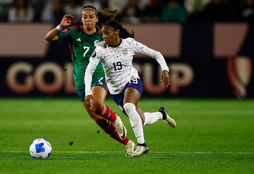 Crystal Dunn in a white jersey runs towards the ball against Mexico during the 2024 Concacaf W Gold Cup