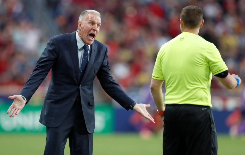 Peter Vermes in a suit yelling at a ref during an Open Cup match