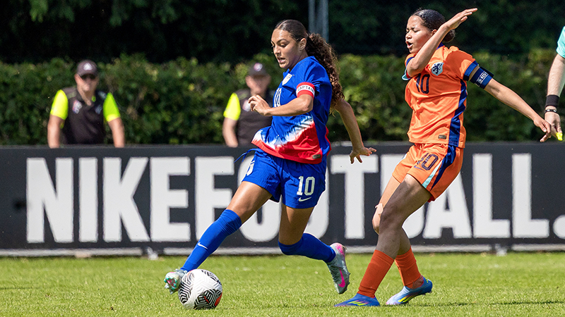 U16 Girls National Team player dribbles past Netherlands player