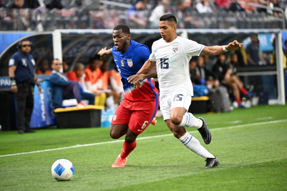 Yunus Musah for the USMNT contests a ball with a Panama player during a match
