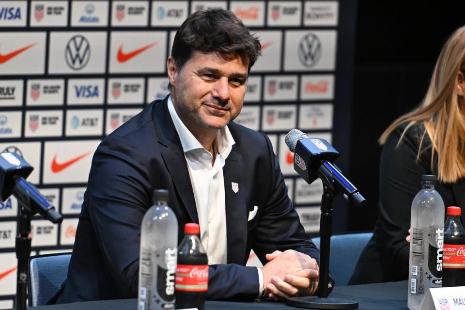 Mauricio Pochettino smiles at a press conference