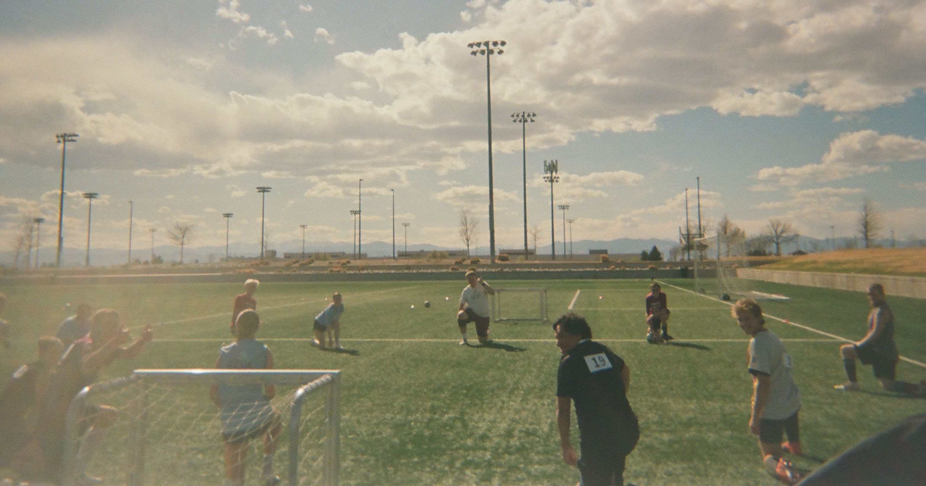 Amputee soccer players training together on an outdoor field.