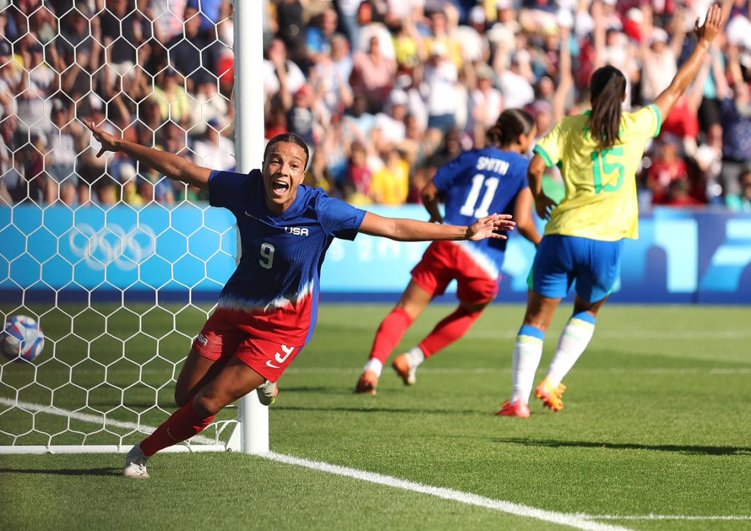 Mallory Swanson celebrates after scoring the game-winning goal in the gold medal match against Brazil.