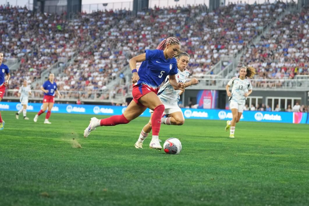 Trinity Rodman dribbles the ball upfield with a Costa Rica player trailing