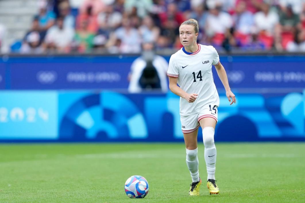 Emily Sonnett dribbles the ball during a match