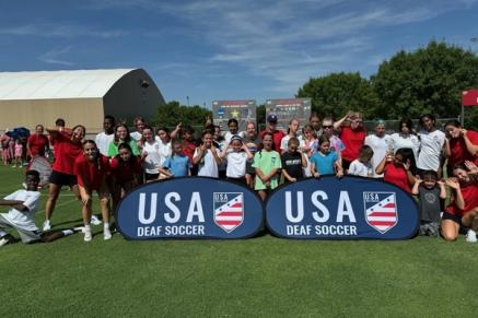 USA Deaf Soccer takes a group photo on a field