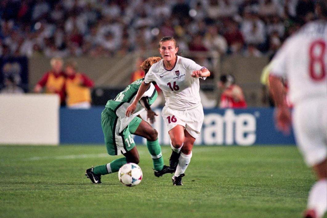 A USA Player dribbles forward with the ball in a 1999 Womens World Cup match against Nigeria